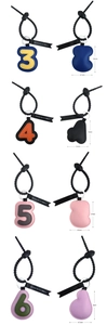 Detailed view of leather number keychains showing dimensions and various color textures