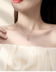 Elegant rose gold crown necklace with shimmering dancing stone on a female model
