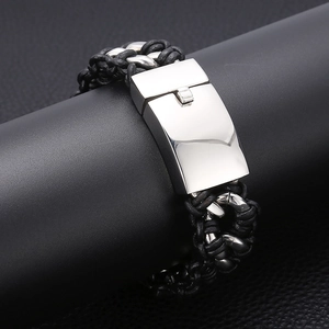 Close-up of men's braided leather bracelet with polished stainless steel clasp detail