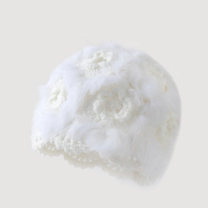 Elegant white knitted beanie hat with plush faux fur texture and floral crochet pattern