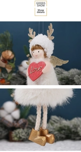 Macro detail of plush Christmas angel doll with golden antlers and red love heart pendant
