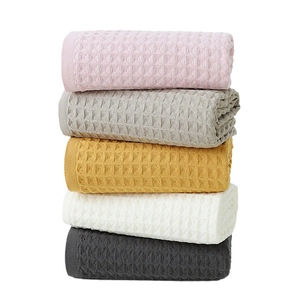 Five-piece set of absorbent cotton waffle towels in pink, grey, yellow, and white