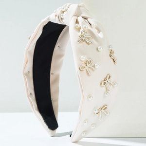 Elegant beige knotted fabric headband with pearls and gold-rimmed butterfly charms
