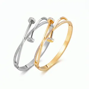 Elegant gold and silver titanium steel nail bracelets with pavé zircons in a crossover design