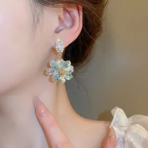 Elegant silver needle flower drop earrings with crystal accents and iridescent petals