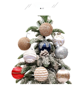 Detail of 8cm painted Christmas balls with sequins and glitter hanging on snowy pine tree