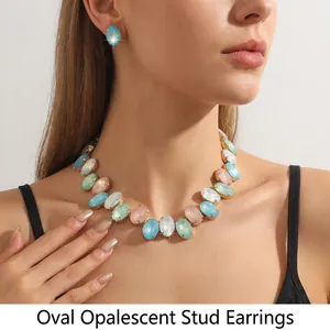 Detail of elegant gold-tone choker and stud earrings set with oval opal stones