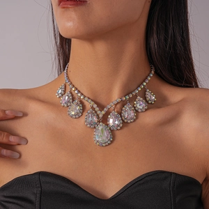 Close-up of elegant silver water-drop crystal pendant necklace on model's neckline
