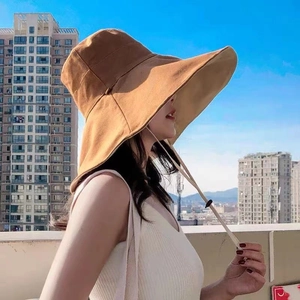 Women's wide brim reversible sun hat in beige with windproof chin strap for outdoor use