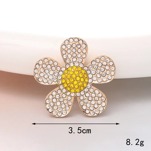 Detailed close-up of 3.5cm rhinestone flower charm with white and yellow crystals