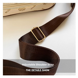 Detail of adjustable woven brown shoulder strap with gold metal buckle and printed bag