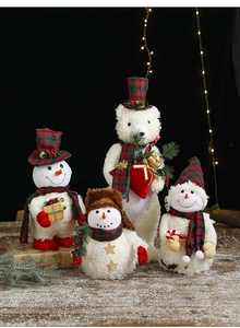 Detailed view of plush Christmas snowmen and bears in festive red and green plaid outfits