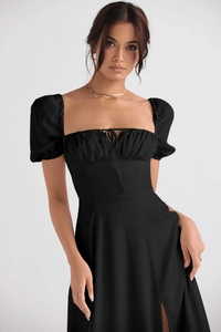 Detail of elegant black bubble sleeve dress with a square neckline and waist tie detail