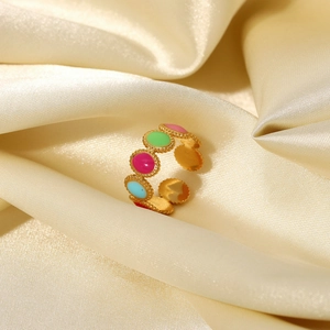Close-up of 18K gold plated ring with five colorful enamel ovals on satin background