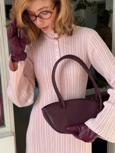 Slim fit light pink knit long sleeve dress paired with deep purple leather gloves and bag