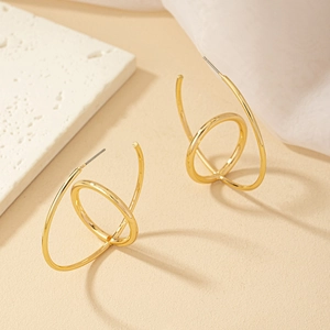 Minimalist gold geometric C-shaped hoop earrings with spiral double-loop design and polished finish
