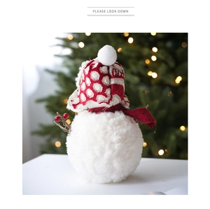 Détail de la poupée bonhomme de neige en peluche avec bonnet rouge et fond de Noël chaud