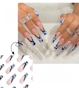 Detail view of long coffin press-on nails with blue tips and black abstract wavy lines