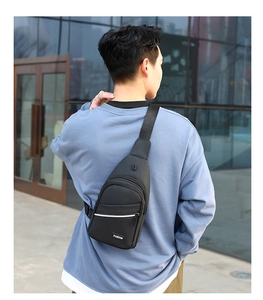 Detail of waterproof nylon chest bag featuring a functional earphone hole and zipper pockets