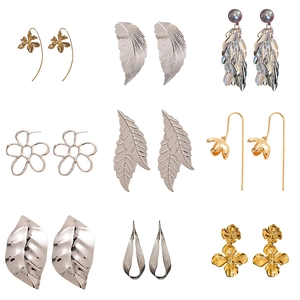 Set of 9 pairs of minimalist gold and silver metal earrings with leaf and floral designs