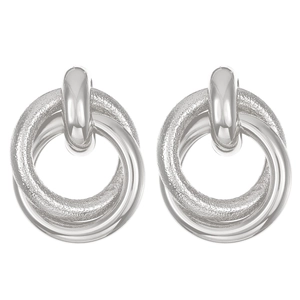 Macro detail of silver layered hoop earrings with polished finish and wavy texture