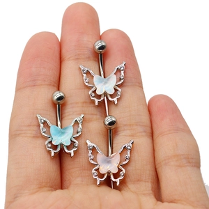 Three minimalist butterfly belly rings in blue, white, and pink held in hand