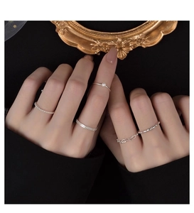 Macro view of S925 silver ring set with freshwater pearl and textured stackable bands