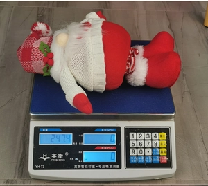 Detailed scale view of a Christmas gnome plush toy weighing approximately 247 grams