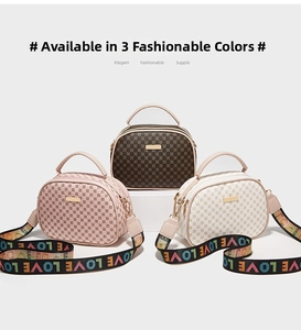 Close-up of three crossbody bags in pink, brown and white with LOVE pattern straps