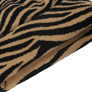 Detailed view of the zebra stripe pattern and tight knit texture of the winter beanie