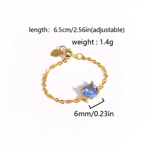 Adjustable gold chain ring with a 6mm round blue gemstone on a clean white background