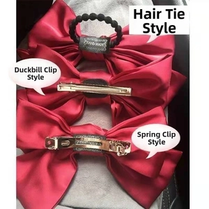 Red satin bow hair clips showing options for hair tie, spring clip, and duckbill clip