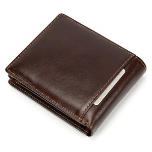 Detail view of genuine leather wallet showing orange stitching and metal accent
