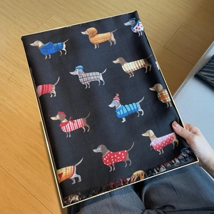 Detail of dachshund print linen scarf with fringes and elegant white gift box packaging