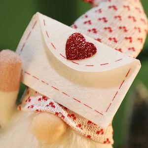 Cartoon Christmas Gnome plush ornament with red striped hat and heart envelope detail