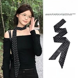 Classic black and white polka dot skinny scarf displayed on model and flat lay