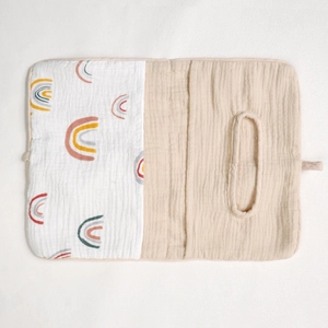 Detail of cotton baby crib organizer showing rainbow pattern and tissue dispenser pocket