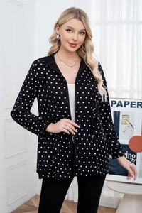 Detail of hooded polka dot jacket featuring adjustable waist drawstring and zipper closure