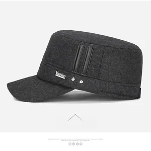 Detail view of winter wool cap with Vashion logo patch, metal studs, and leather straps
