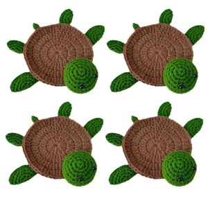 Set of four handmade crochet turtle coasters with brown shells and green limbs on white backdrop