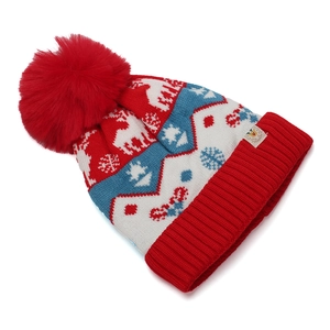 Detail of winter knit hat with red pompom, reindeer jacquard pattern and rib cuff