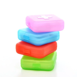Portable 4-compartment plastic pill box in four colors with medical cross design