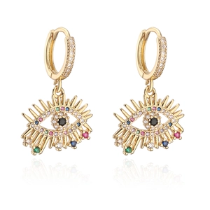 Golden evil eye drop earrings with zircon insets and black center stone on white backdrop