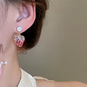 Pink gradient heart stud earrings with sparkling sequins and cubic zirconia on model