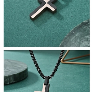 Detail of two-tone stainless steel cross pendant on black box chain necklace