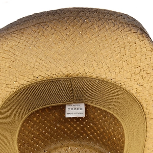 Close-up of western straw hat interior with 100% paper label and elastic sweatband