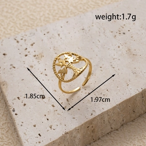 Gold stainless steel tree of life open ring on beige stone base with size markings