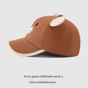 Detail of a brown children's bear baseball cap with 3D ears and fine cotton stitching