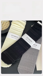 Detail of breathable hollow-out knit socks featuring 200% stretch and 99% resilience