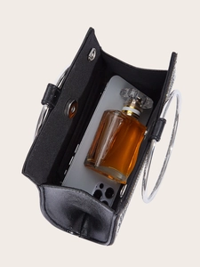 Interior view of black evening bag showing capacity for smartphone and perfume